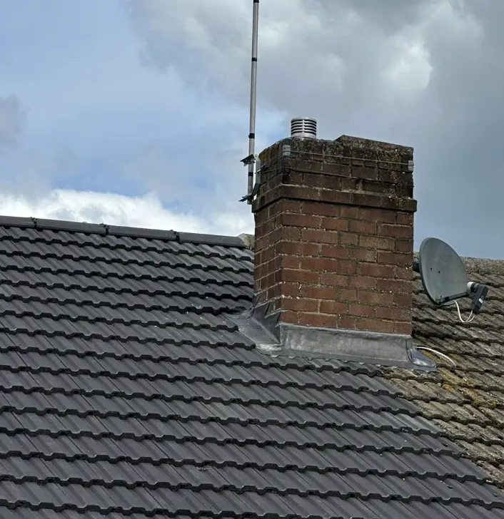 Chimney stack and tiled roof with new pointing